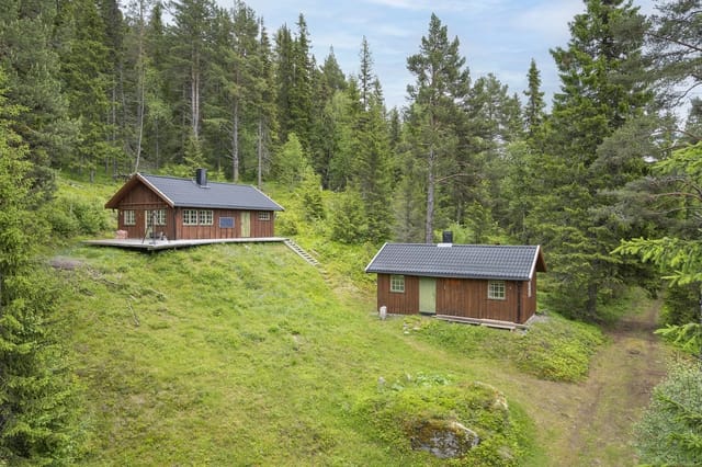 The property is situated on a sloping, privately owned natural plot.