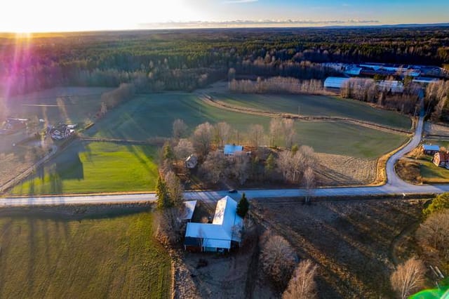Front view of the country home and outbuildings