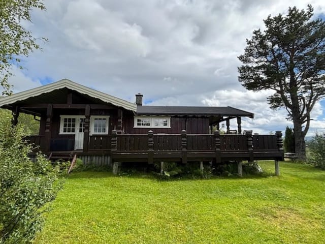 Exterior view of the cabin with terrace and scenic surroundings