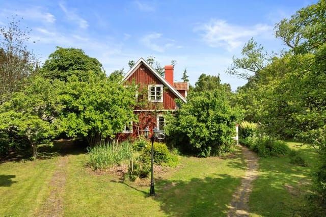 Front view of the farmhouse and garden