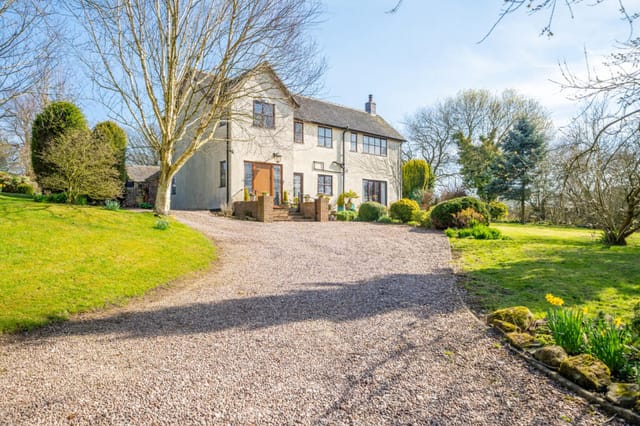 Front view of the farmhouse and driveway