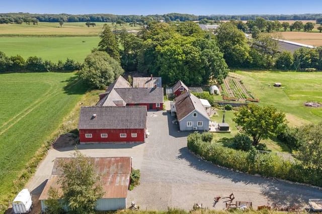 Front view of the country home and outbuildings