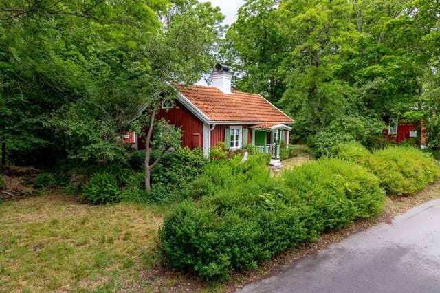 Front view of the red timber cottage