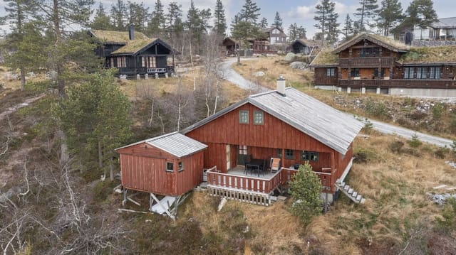 The plot is about 1.1 decares and consists of a natural lot with open space around the building and views of the surrounding terrain.