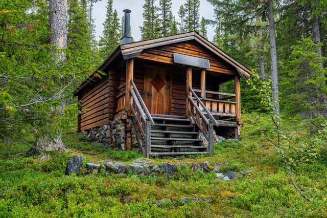 Exterior view of the cabin and surrounding landscape