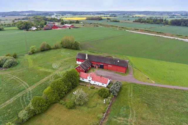 Exterior view of the farmhouse and surrounding land