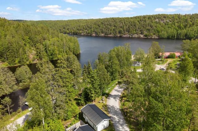 Exterior view of the cottage with lake in the background