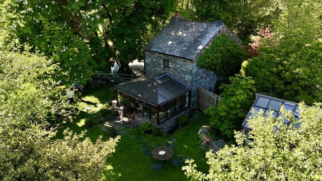 Aerial view of the cottage and surrounding land