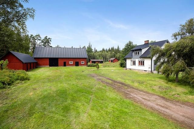 Front view of the country home and barns