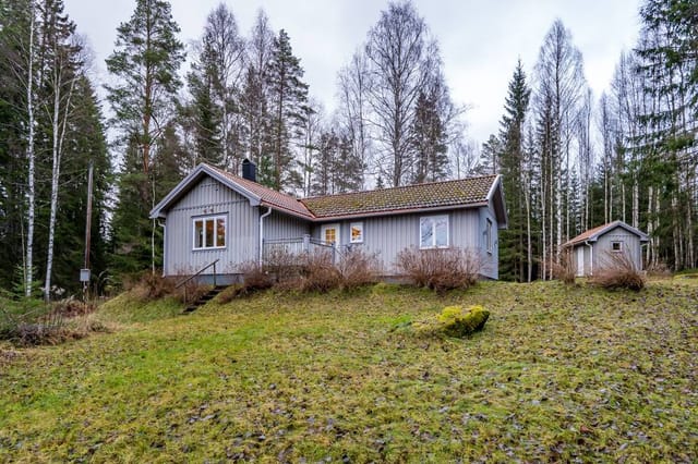 Exterior view of the house with lake in the background