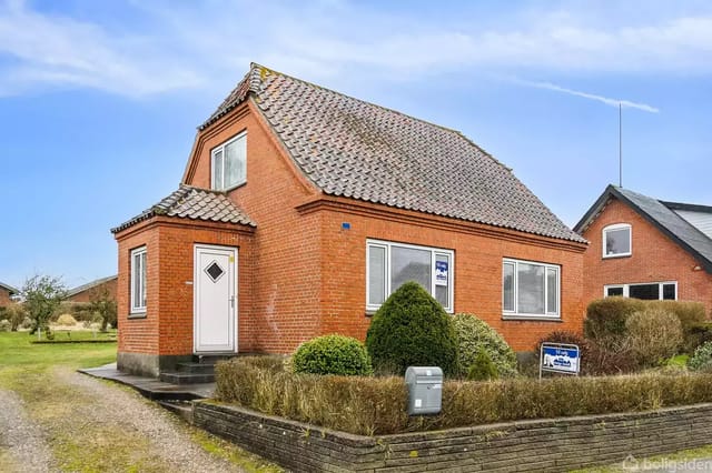 Red brick house with slate roof and garden