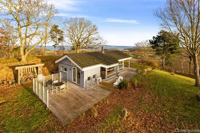 Holiday home on a wooded hill with water view.